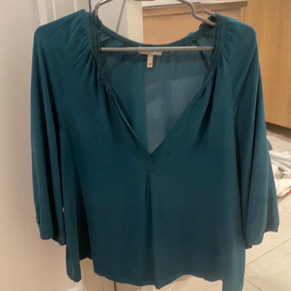 100% silk. Beautiful teal blouse